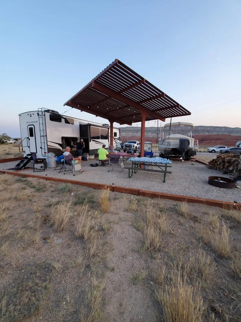 Slide: The Image of Outdoor campsite with RV, boat, and people under a canopy, 1987 Custom Tour Boat and Business. - 33