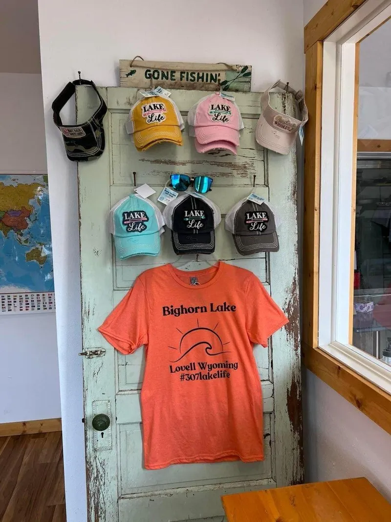 Slide: The Image of Lake Life hats and Bighorn Lake t-shirt on display in a rustic shop. - 39