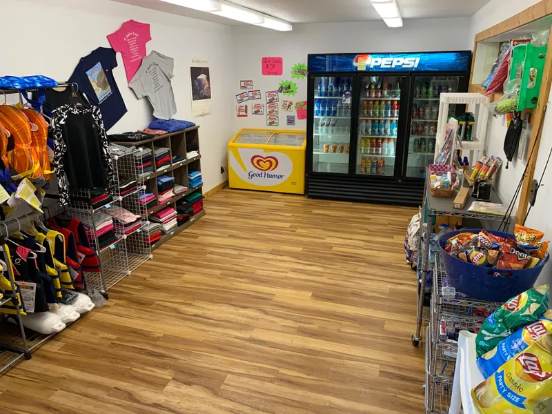 Slide: The Image of Small convenience store with snacks, drinks, and souvenirs, featuring a Pepsi fridge and Good Humor ice cream freezer. - 40