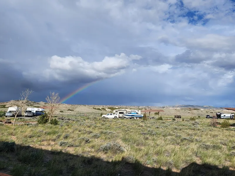 Slide: The Image of Tour boat and business vehicles under a rainbow in a vast grassy landscape, 1987 Custom model. - 42