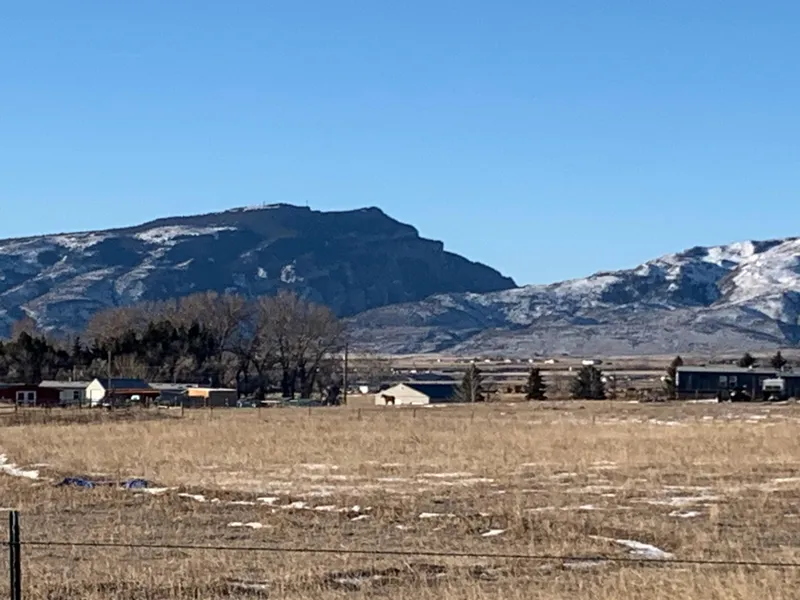 Slide: The Image of Rural landscape with snow-capped mountains and scattered houses under a clear blue sky. - 44