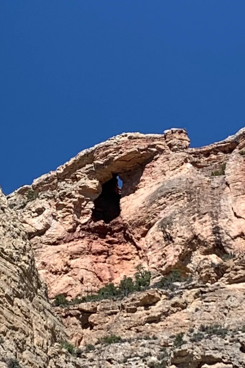 Slide: The Image of Rock formation with natural arch under clear blue sky. - 5