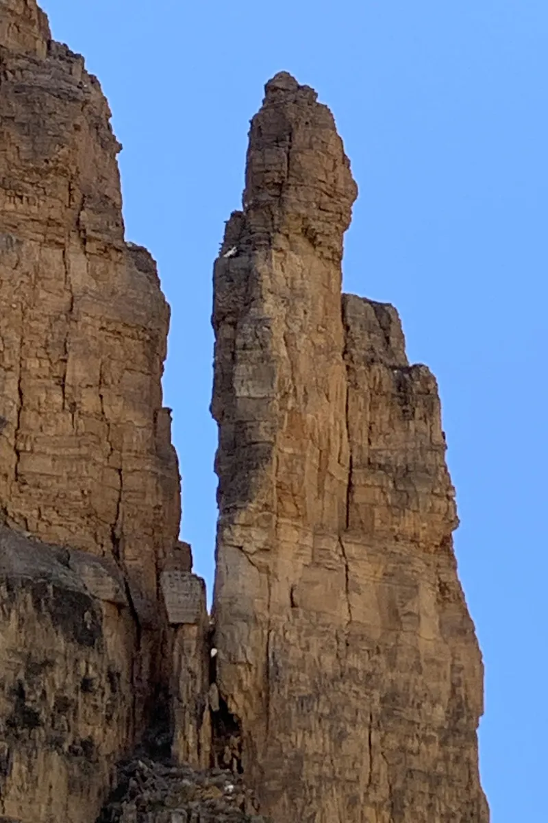 Slide: The Image of Tall rock formations against a clear blue sky. - 6