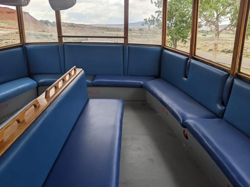 Slide: The Image of Interior of a 1987 Custom tour boat with blue seating and panoramic windows. - 7