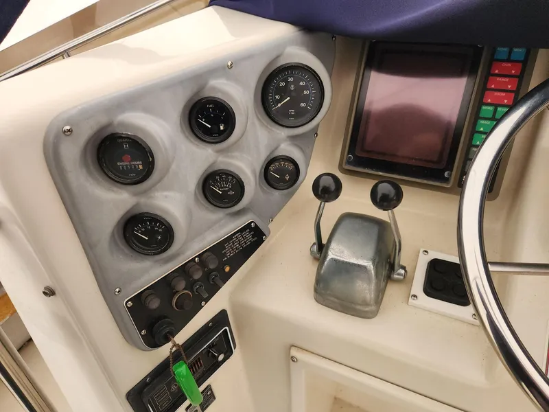 Slide: The Image of 1988 Silverton 40 Convertible dashboard with gauges, controls, and navigation screen. - 12