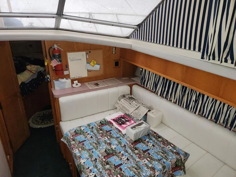 Slide: The Image of Interior of 1988 Silverton 40 Convertible yacht with cozy seating and nautical decor. - 17