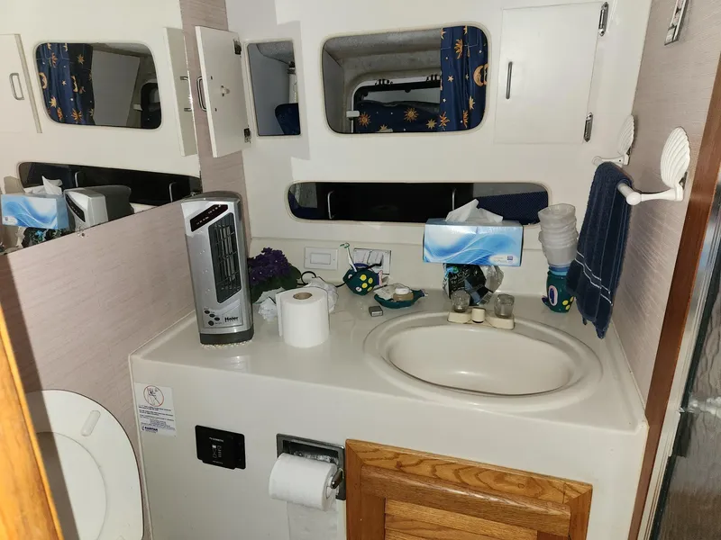 Slide: The Image of 1988 Silverton 40 Convertible bathroom with sink, mirror, and storage cabinets. - 20