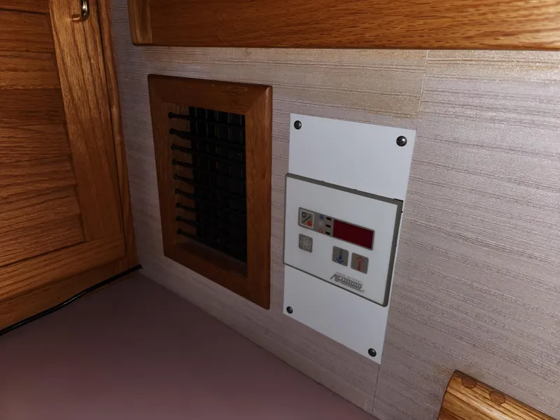 Slide: The Image of Control panel and vent inside a 1988 Silverton 40 Convertible boat cabin. - 23