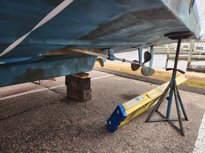 Slide: The Image of 1988 Silverton 40 Convertible boat on dry dock, showing propeller and hull maintenance setup. - 4