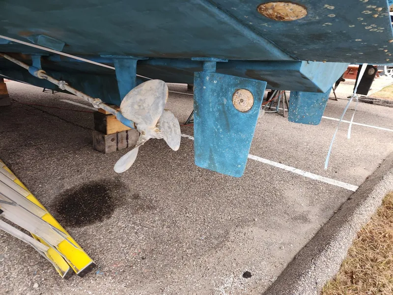 Slide: The Image of 1988 Silverton 40 Convertible boat underside with propeller and rudder, on dry dock. - 5