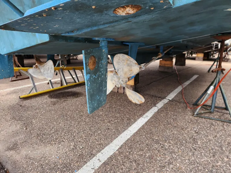 Slide: The Image of 1988 Silverton 40 Convertible boat propeller and rudder in dry dock. - 6