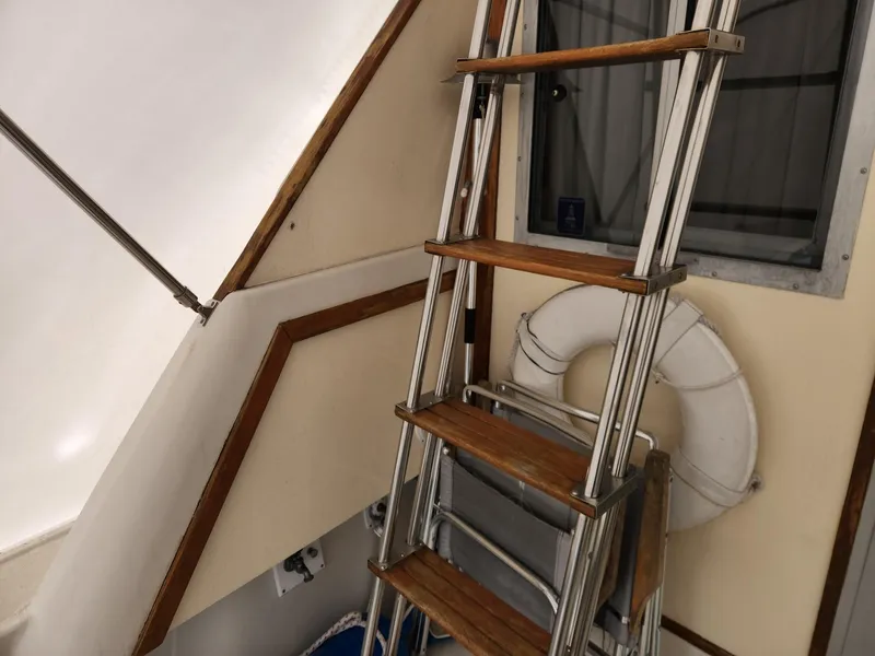 Slide: The Image of 1988 Silverton 40 Convertible boat interior with ladder and life preserver. - 9