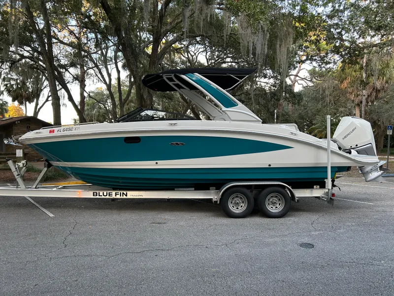 Slide: The Image of 2022 Sea Ray SDX 270 Outboard boat on Blue Fin trailer, parked on a street. - 1