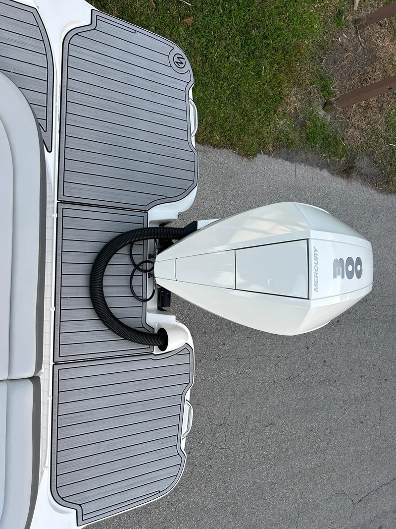 Slide: The Image of 2022 Sea Ray SDX 270 Outboard motor on a boat docked on a textured surface. - 10