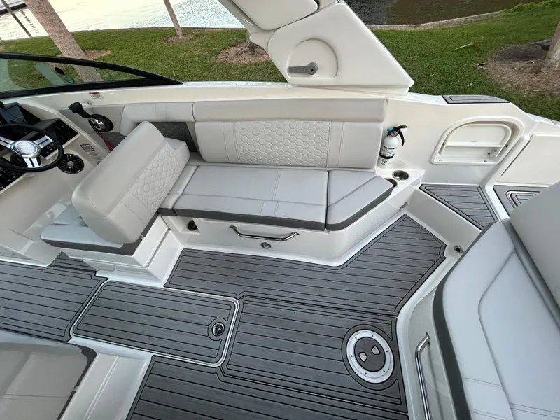 Slide: The Image of 2022 Sea Ray SDX 270 Outboard interior with gray seating and deck. - 14