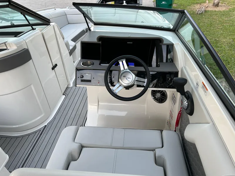 Slide: The Image of 2022 Sea Ray SDX 270 Outboard boat interior, featuring helm and seating area. - 22