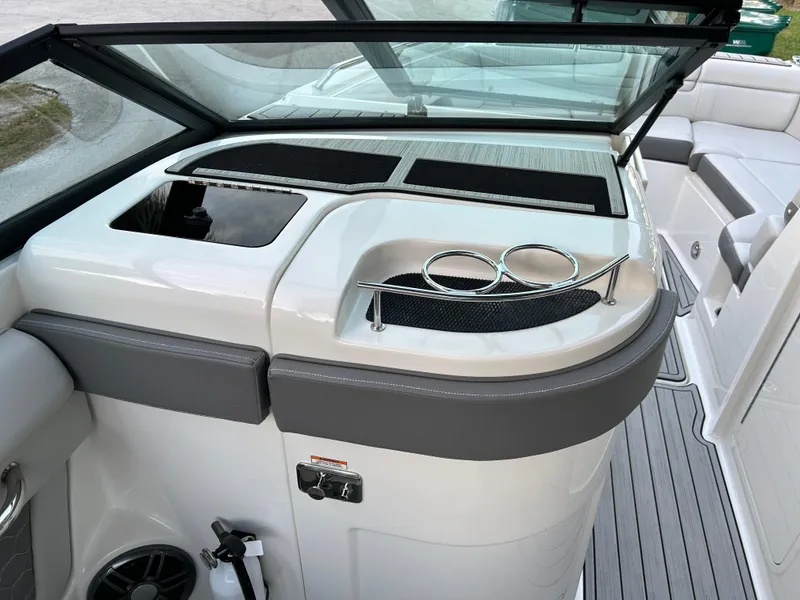 Slide: The Image of 2022 Sea Ray SDX 270 Outboard boat interior with cup holders and storage compartments. - 26
