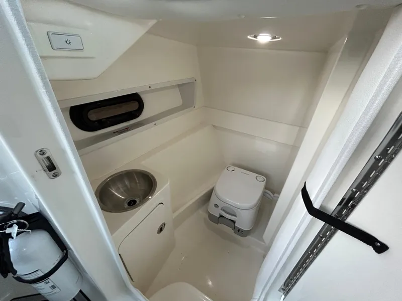 Slide: The Image of 2022 Sea Ray SDX 270 Outboard boat interior bathroom with sink and toilet. - 27