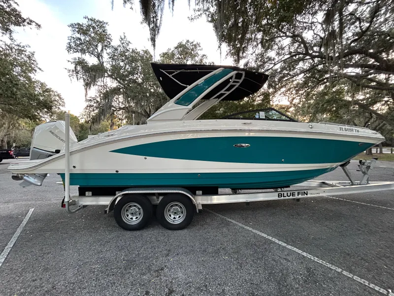 Slide: The Image of 2022 Sea Ray SDX 270 Outboard boat on a trailer in a parking lot. - 3