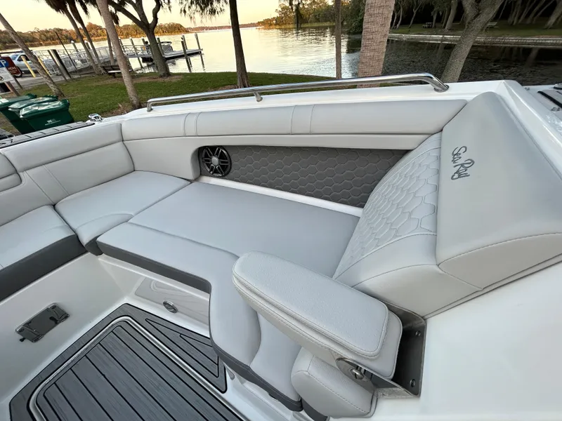 Slide: The Image of 2022 Sea Ray SDX 270 Outboard boat interior with luxurious seating and scenic lake view. - 30
