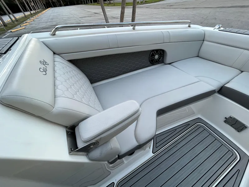 Slide: The Image of 2022 Sea Ray SDX 270 Outboard boat interior with white leather seating and speaker. - 31