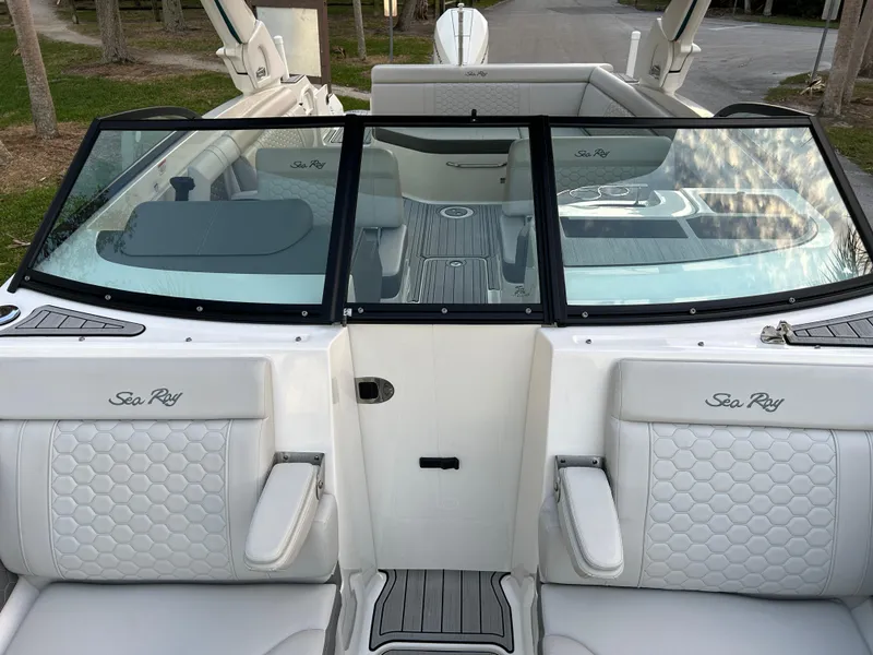 Slide: The Image of 2022 Sea Ray SDX 270 Outboard boat interior with white seating and windshield. - 37