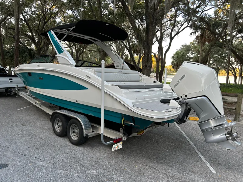 Slide: The Image of 2022 Sea Ray SDX 270 Outboard boat on trailer in parking lot. - 4
