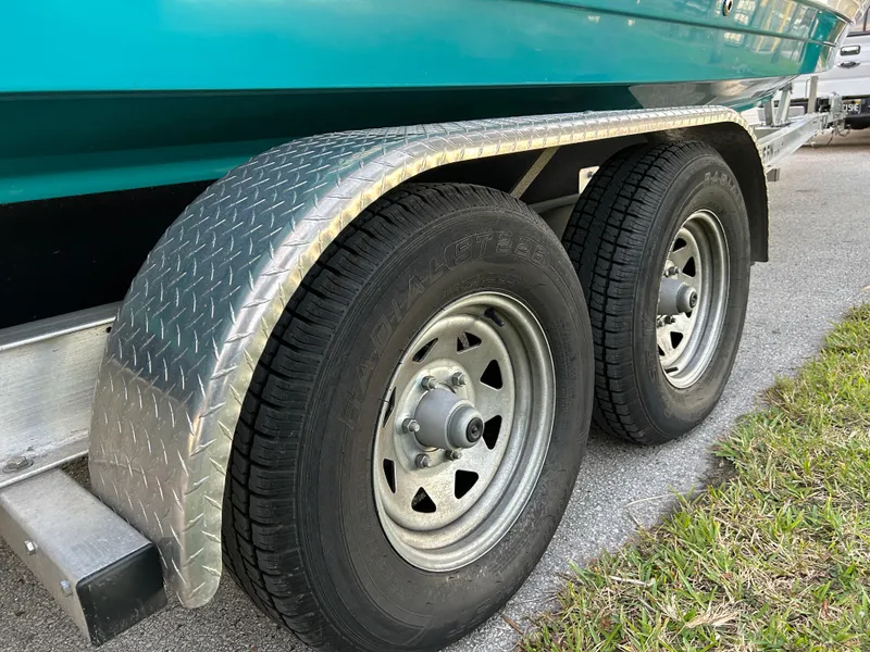 Slide: The Image of 2022 Sea Ray SDX 270 Outboard trailer with dual wheels and diamond plate fender. - 42