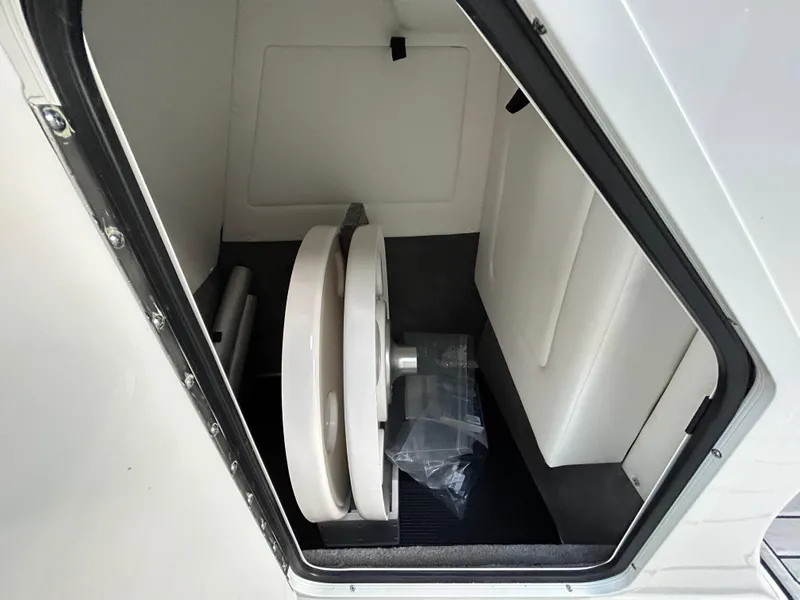 Slide: The Image of 2022 Sea Ray SDX 270 Outboard storage compartment with marine equipment. - 45