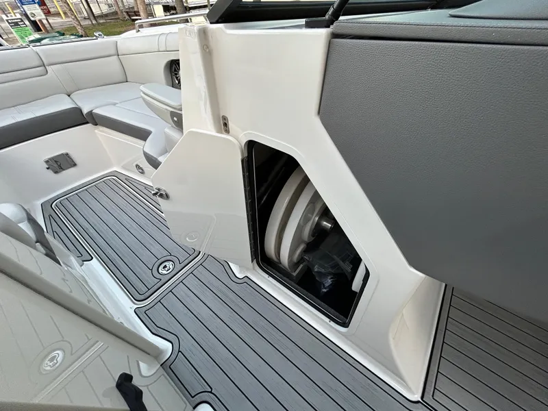 Slide: The Image of 2022 Sea Ray SDX 270 Outboard interior with open storage compartment and seating area. - 46