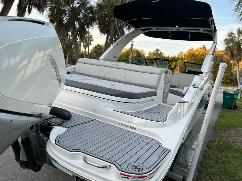 Slide: The Image of 2022 Sea Ray SDX 270 Outboard boat with Mercury engine, docked near palm trees. - 9