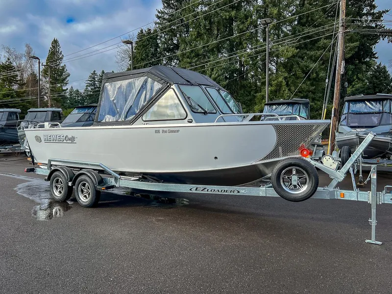 Slide: The Image of 2025 Hewescraft 210 Sea Runner ET boat on trailer, parked outdoors. - 1