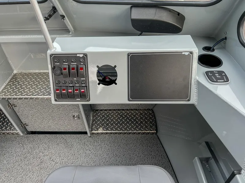 Slide: The Image of 2025 Hewescraft 210 Sea Runner ET dashboard with control panel and storage. - 10
