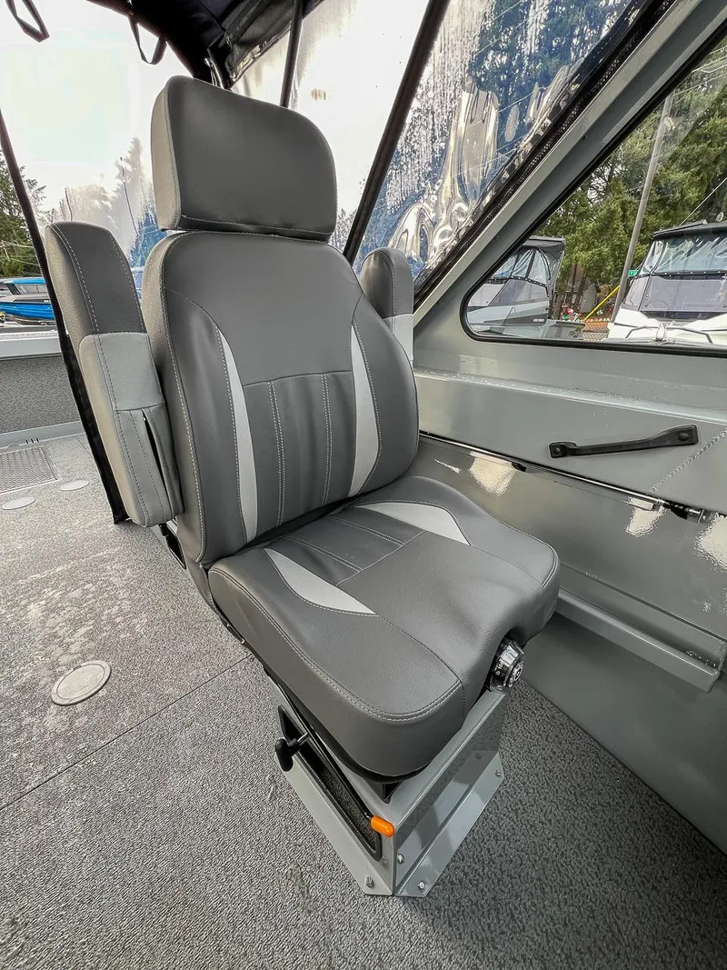 Slide: The Image of 2025 Hewescraft 210 Sea Runner ET interior with a sleek, gray captain's chair. - 13