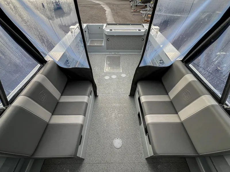Slide: The Image of Interior of 2025 Hewescraft 210 Sea Runner ET with gray seating and clear windows. - 14