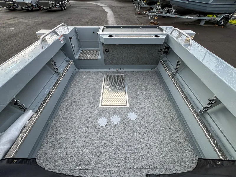 Slide: The Image of 2025 Hewescraft 210 Sea Runner ET boat interior with spacious deck and storage compartments. - 15