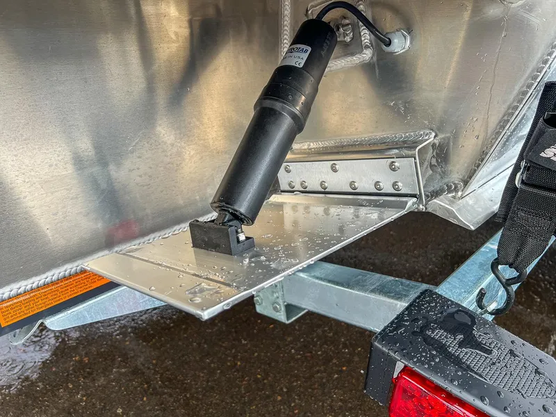 Slide: The Image of Close-up of 2025 Hewescraft 210 Sea Runner ET trim tab mechanism. - 20