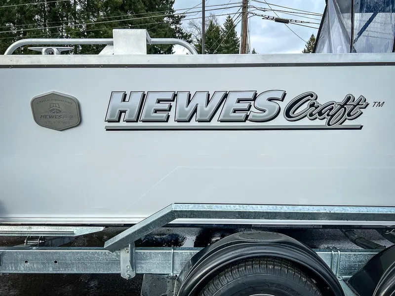 Slide: The Image of 2025 Hewescraft 210 Sea Runner ET boat logo on trailer. - 22