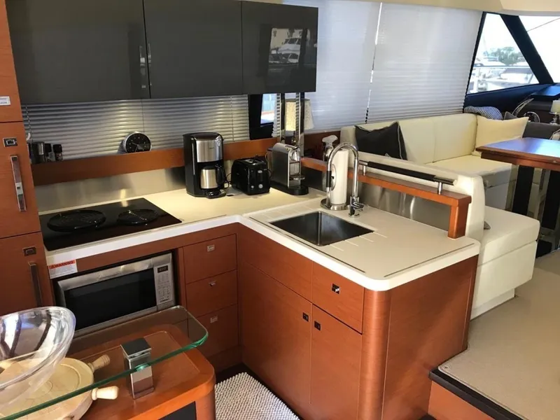 Slide: The Image of Modern kitchen in a 2015 Prestige 550 yacht with appliances and sleek cabinetry. - 13