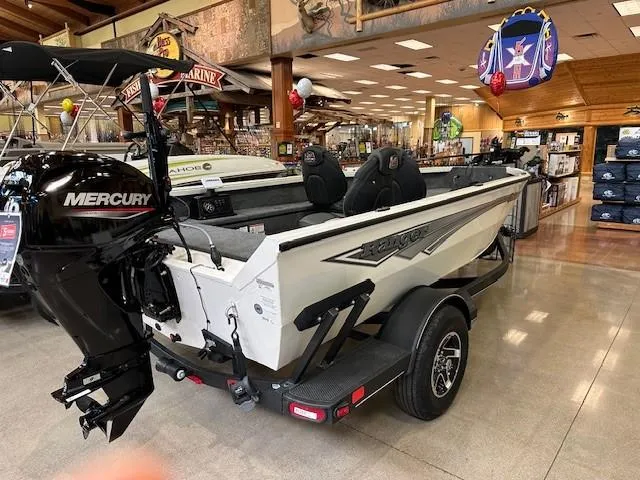 Slide: The Image of 2024 Ranger VS1665T fishing boat on trailer, parked on roadside. - 1