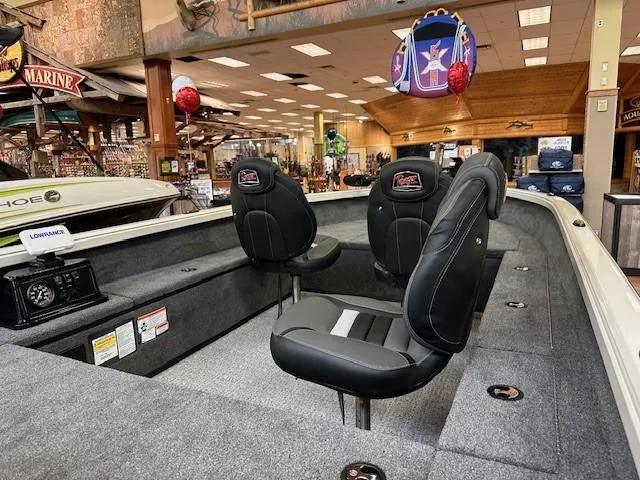 Slide: The Image of 2024 Ranger VS1665T boat on trailer, parked on pavement under clear blue sky. - 2