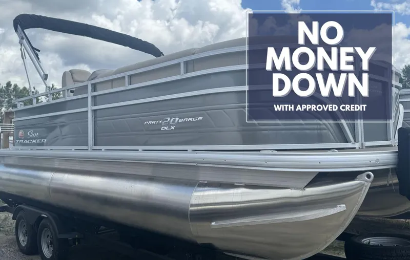 The Image of 2024 Sun Tracker Party Barge 20 DLX pontoon boat under a cloudy sky. - 0