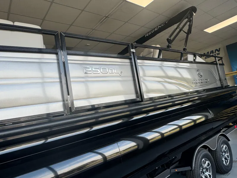 Slide: The Image of 2024 Regency 250 DL3 pontoon boat in showroom. - 3