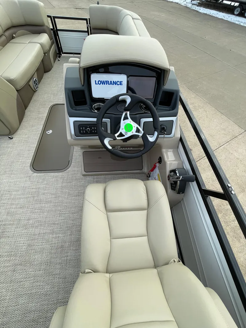 Slide: The Image of 2024 Regency 230 DL3 boat interior with steering wheel and Lowrance display. - 4