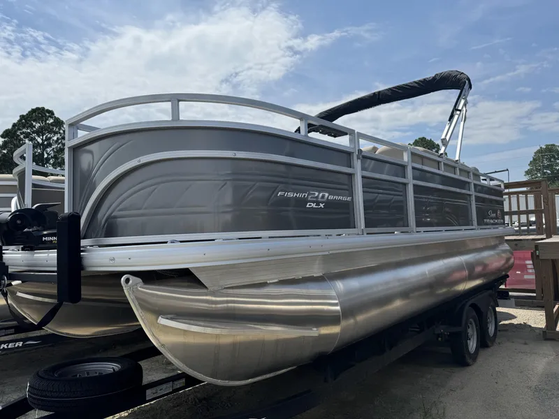 The Image of 2024 Sun Tracker Fishin' Barge 20 DLX pontoon boat on trailer. - 1