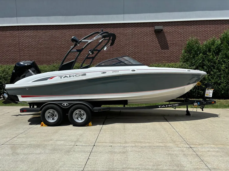Slide: The Image of 2024 Tahoe 210 S boat on trailer, parked outdoors. - 0