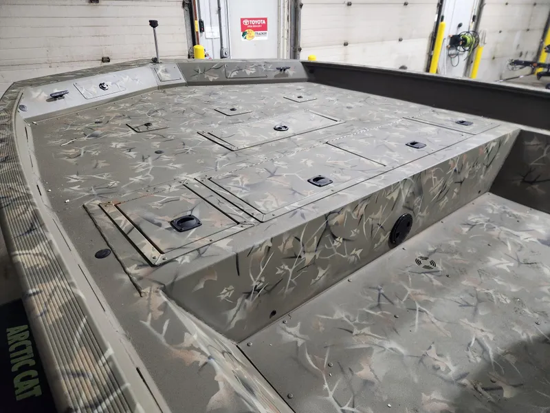 Slide: The Image of 2024 Tracker Grizzly 2072 CC boat with outboard motor in a parking lot. - 2