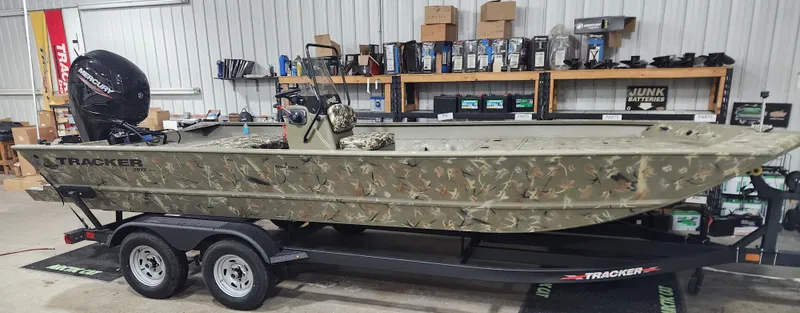 Slide: The Image of 2024 Tracker Grizzly 2072 CC boat on a trailer in a garage. - 5