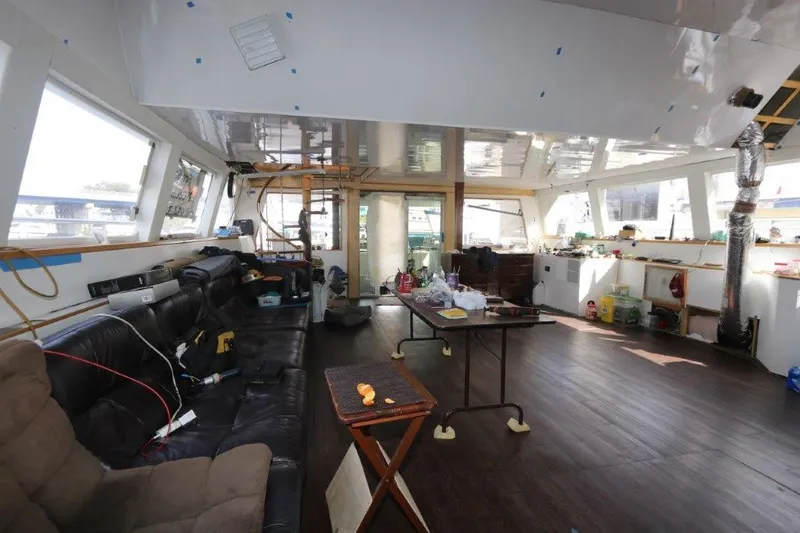 Slide: The Image of Interior of a 1996 Mares Motor Yacht under renovation, featuring a spacious cabin. - 3