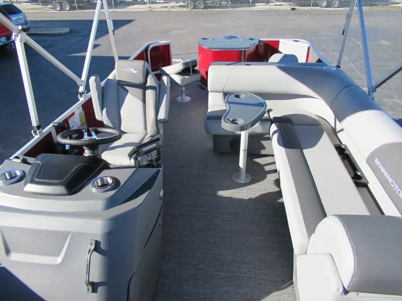 Slide: The Image of 2024 Bennington 22 SVF pontoon boat interior with seating and helm station. - 2
